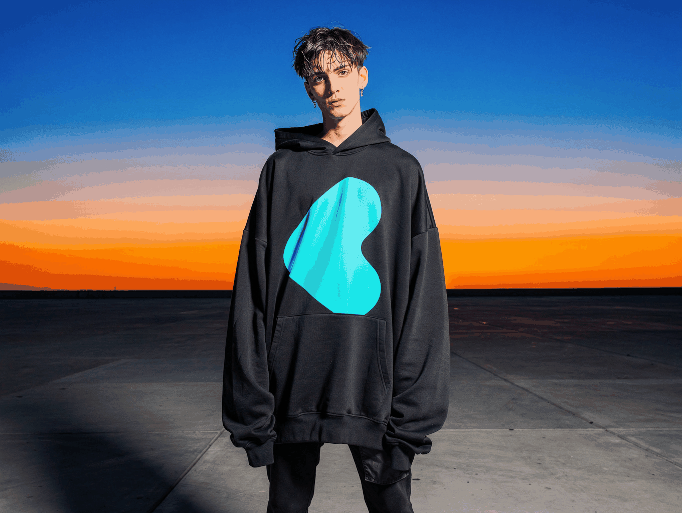 Model wearing oversized streetwear hoodie in urban setting